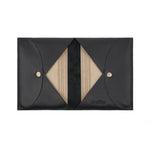 Load image into Gallery viewer, Open Draft-8 FOLD leather cardholder in black, displaying multiple stacked cards inside geometric V-shaped slots.

