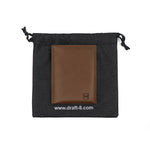 Load image into Gallery viewer, Draft-8 FOLD leather cardholder packaging with a black drawstring pouch and debossed brown wallet inside.

