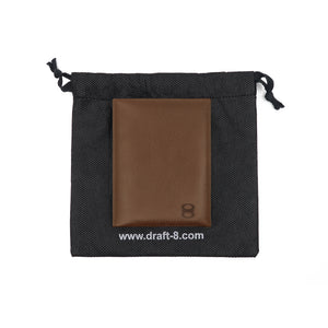 Draft-8 FOLD leather cardholder packaging with a black drawstring pouch and debossed brown wallet inside.
