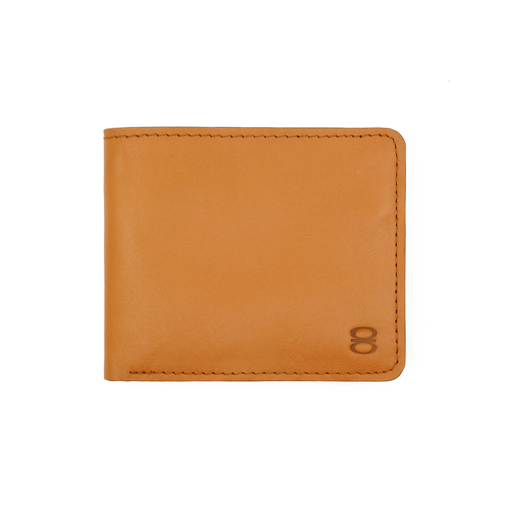 Front view of Draft-8 SWITCH wallet in camel-colored vegetable-tanned leather, featuring minimalist stitching and embossed logo.
