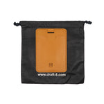 Load image into Gallery viewer, Draft-8 SIDE card holder in camel vegetable-tanned leather displayed on branded fabric pouch. Elegant and sustainable packaging highlighting premium craftsmanship and eco-conscious design.

