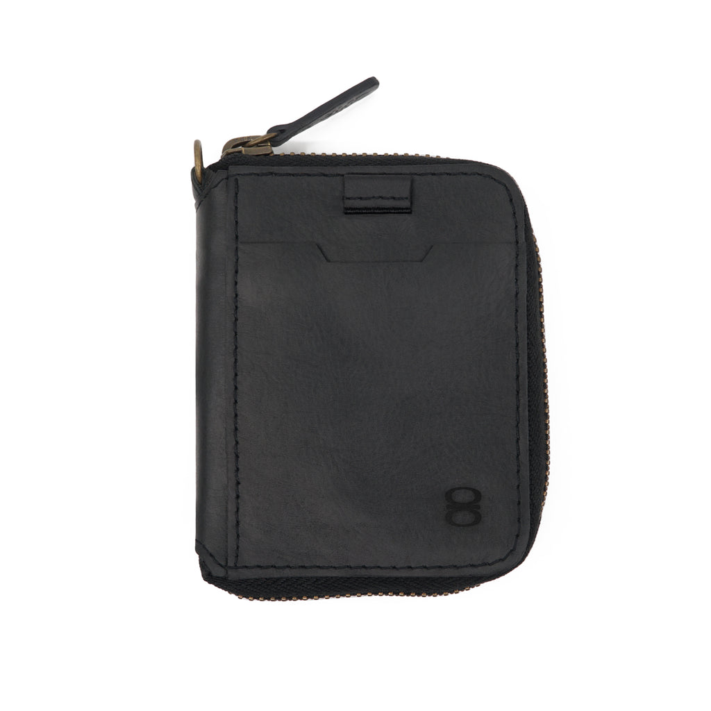 Draft-8 Spin wallet in black vegetable-tanned leather with secure zipper closure and minimalist exterior card slot. Handcrafted premium accessory for refined and sustainable everyday carry.
