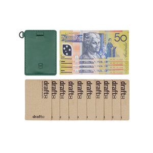 Front view of Draft8 green leather cardholder with Australian dollar bills and cardboard placeholders, minimalist design for daily use and quick card access.

