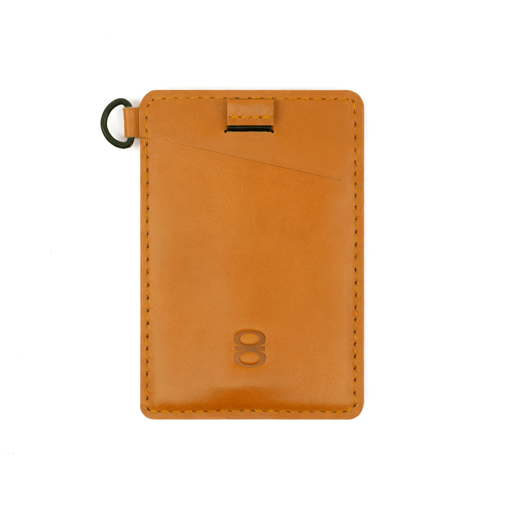 Close-up of the camel-colored Draft8 minimalist leather cardholder with pull tab and ring loop for efficient daily use.